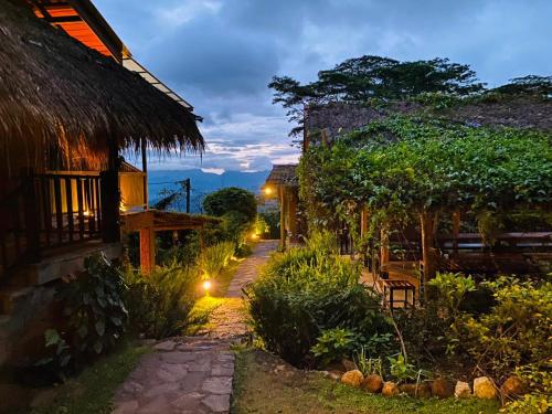 a garden at night with a house and a pathway at Hanthana Eco Lodge in Kandy