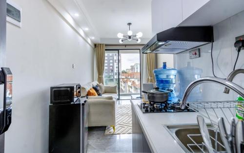 a kitchen with a sink and a stove top oven at Kilimani finest - One Bedroom Apartment in Nairobi