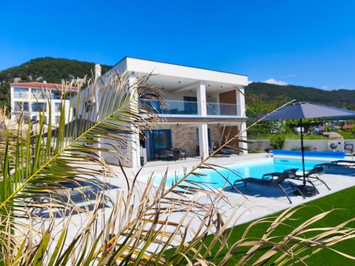 a villa with a swimming pool and a house at Villa Milamar in Banjol