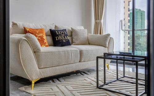 a living room with a couch and a glass table at Kilimani finest - One Bedroom Apartment in Nairobi