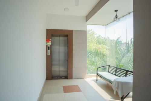 a hospital hallway with a bed and a window at Ahuja Residency Parklane in Gurgaon