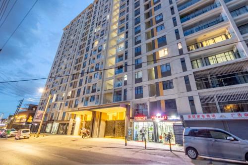 a tall building with a van parked in front of it at Kilimani finest - One Bedroom Apartment in Nairobi