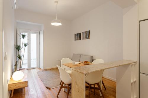a kitchen and dining room with a table and chairs at Calçada de Santo Amaro Apartments in Lisbon