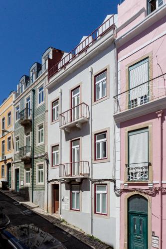 a row of colorful buildings on a street at Calçada de Santo Amaro Apartments in Lisbon