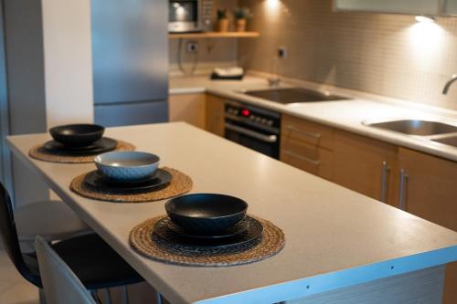 a kitchen with three bowls sitting on a counter at Loui's Garden House in Thessaloniki