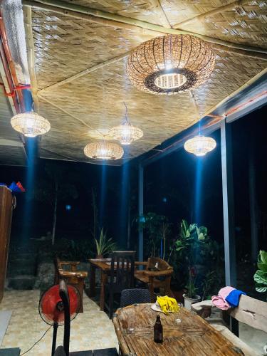 a dining room with tables and chandeliers at Middle bedroom, McKirdy's Farm in Sison