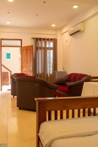 a living room with two couches and a couch at Hotel Coconut Bar Sea Lodge in Beruwala