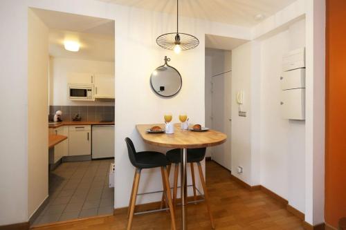 une petite cuisine avec une table et deux chaises dans l'établissement 302 sejournez dans un studio de charme paris 5, à Paris