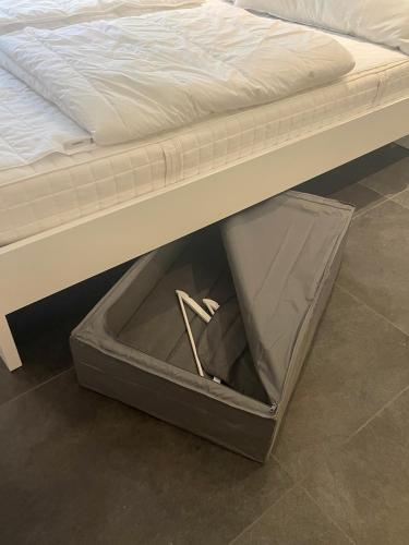 an open box under a bed with a mattress at Max Apartments in Schaffhausen