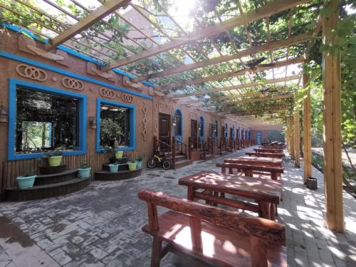 a row of wooden benches in a building with a roof at turpan Ah Fanti Village in Turfan