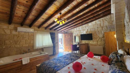 a bedroom with a bed and a bath tub at Yıldız Hotel in Urgup