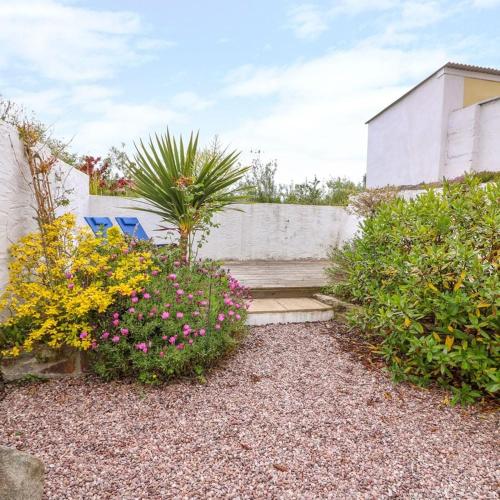a garden with some flowers and a staircase at Characterful and quirky cottage in beautiful Pembs in Fishguard