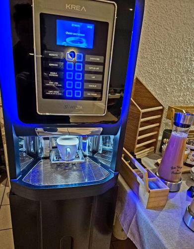 a krec vending machine with a cell phone in it at Cit'Hôtel Le Quai 9 , ex Le Challans in Challans