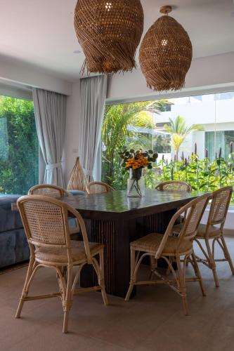 a dining room with a table and chairs at Selina Serenity Rawai Phuket in Rawai Beach