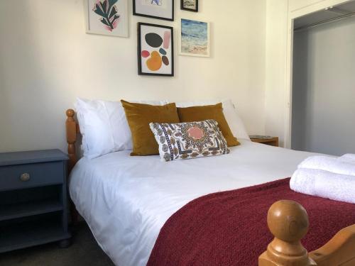 a bedroom with a bed with a pillow on it at Stylish Room Close to Beaches in Falmouth