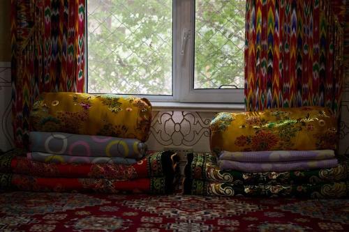 a room with two chairs in front of a window at turpan Ah Fanti Village in Turfan