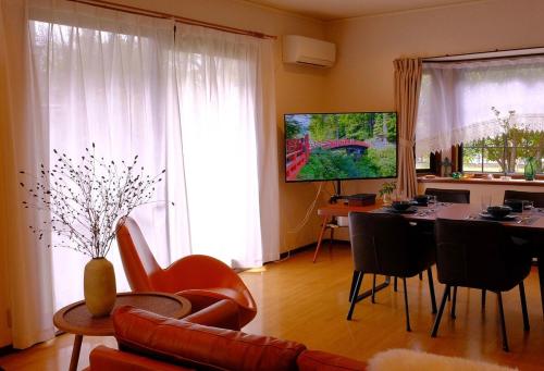 a living room with a table and a dining room at azabu living in Fukuoka
