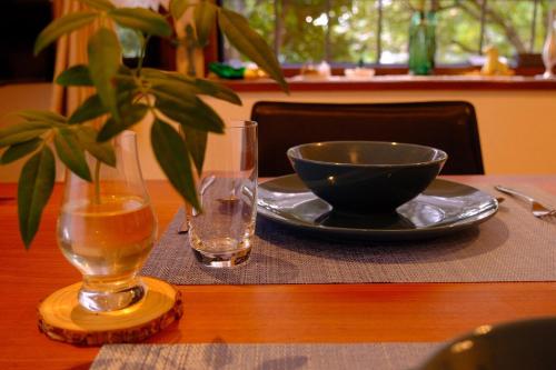 a table with a plate and a bowl and a glass at azabu living in Fukuoka