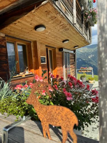 a wooden deer ornament on the front of a house at Ustreia Orta in Lohn