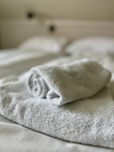 a pile of white towels sitting on a bed at Budget apartment in Gravdal in Gravdal