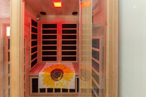 a room with a sunflower painted on the wall at Sunflower House with Jacuzzy and Sauna in Vitanje