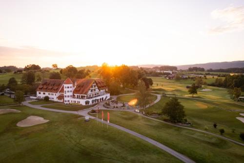 an aerial view of a house on a golf course at Golfhotel Bodensee by Michael Ritter in Weißensberg