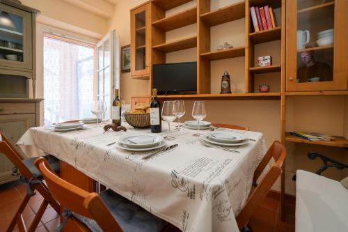 a dining room table with a white table cloth and wine glasses at Sandy House, Vista Mare e Relax a La Culla in Culla