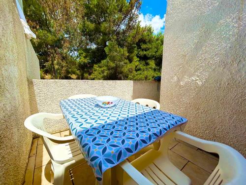 a blue and white table and chairs on a balcony at Summer Holiday - Torre Vado in Torre Vado