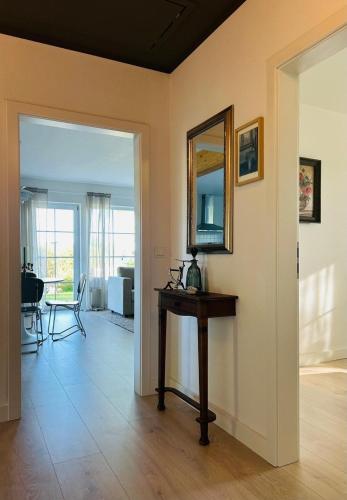 a room with a table and a mirror on a wall at Ferienhaus Landleven in Saal