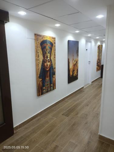 a room with three paintings on the wall at Salma Hotel Cairo in Cairo
