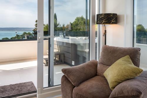 a living room with a couch in front of a window at Penthouse FRANITA 50 meters from the beach in Kaštela