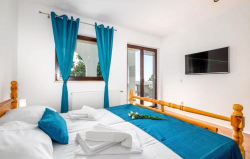 a bedroom with a large bed with blue curtains at Vila Iris - Opatija by Villas Guide in Breza