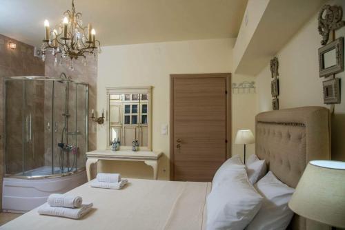 a bedroom with a bed and a shower and a sink at Katerina's garden Apartment 2 - Tertsa Ierapetra in Térsa