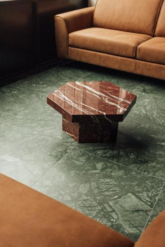 a living room with a couch and a glass coffee table at Getaway Studios Liège in Liège