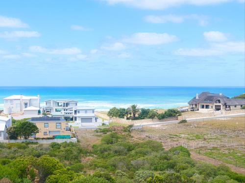an aerial view of houses and the ocean at Fynbos Hill Luxury Accommodation in Agulhas