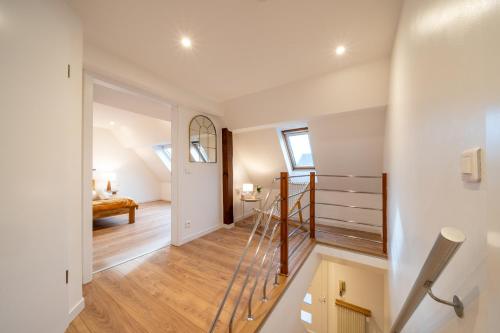 a hallway with a staircase and a room with a stair case at Le Refuge Pétillant - Terrasse et Jardin in Haguenau