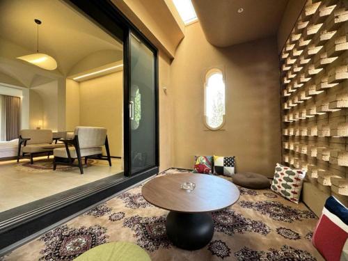 a living room with a table and a dining room at turpan Ah Fanti Village in Turfan