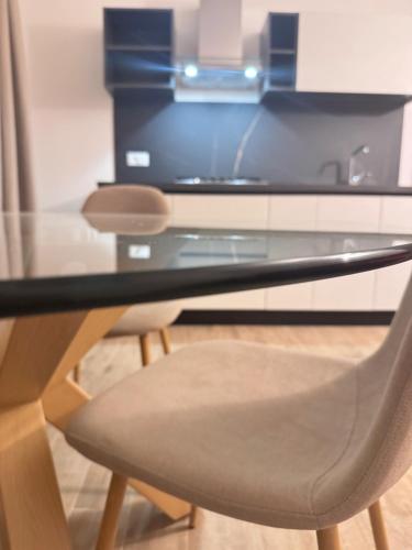 a glass table with a chair in a room at Galaxy Rooms Tropea in Drapia
