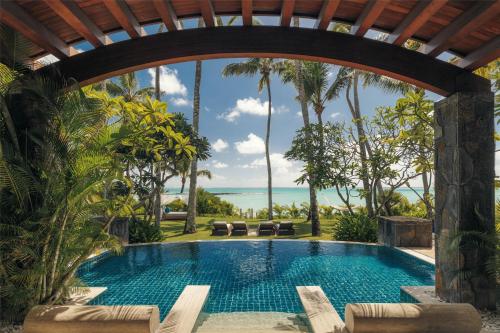a swimming pool with a view of the ocean at One&Only Le Saint Géran, Mauritius in Belle Mare