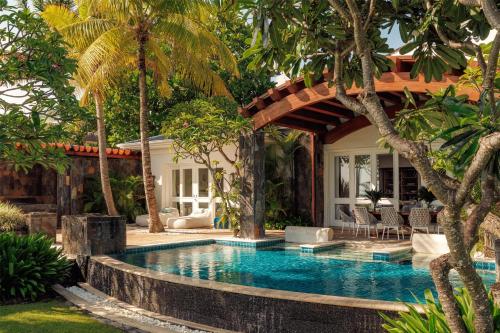 a swimming pool in front of a villa at One&Only Le Saint Géran, Mauritius in Belle Mare
