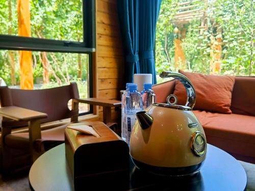 a tea kettle sitting on a table in a living room at turpan Ah Fanti Village in Turfan