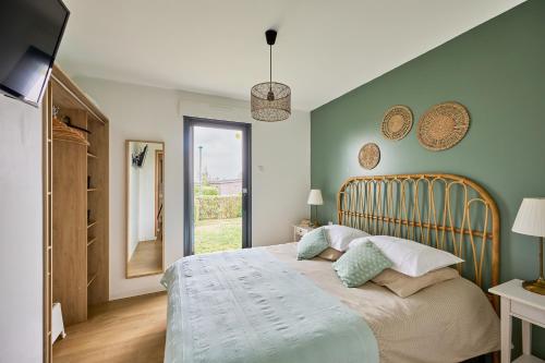 une chambre avec un grand lit et une fenêtre dans l'établissement La Côte des îles - à 600m de la plage, à Les Moitiers-dʼAllonne