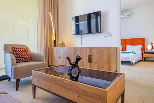 a living room with a dog statue in a coffee table at The Edge in Bijilo