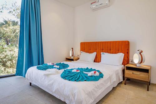 a bedroom with a bed with two towels on it at The Edge in Bijilo