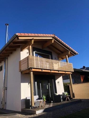 a house with a deck on top of it at Ferienhaus K 39 a - Chiemgau Karte in Inzell