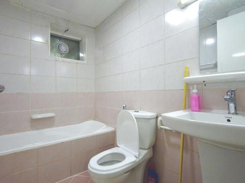 a bathroom with a toilet and a sink at One Master Bedroom Fully Furnished in Sharjah