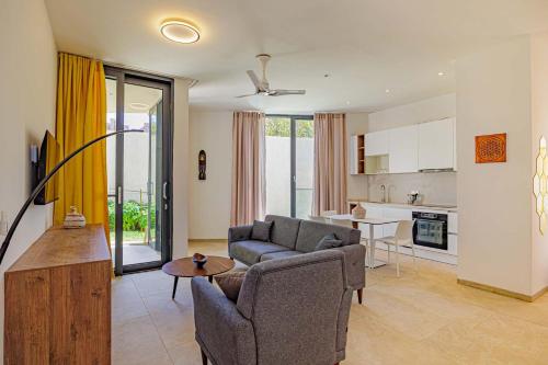 a living room with a couch and a table at The Edge in Bijilo