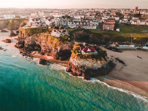 an aerial view of a house on a cliff near the ocean at Modern, spacious surf retreat in a prime location in Newquay