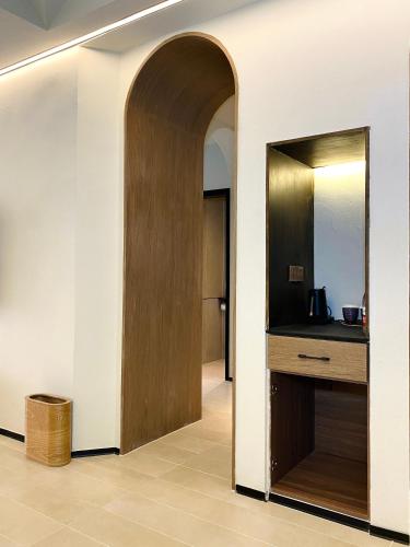 an archway leading into a room with a mirror at turpan Ah Fanti Village in Turfan