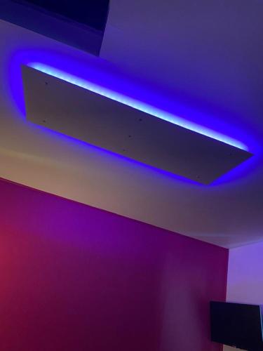 a ceiling with a blue light and purple wall at Le domaine de Périolat in Le François